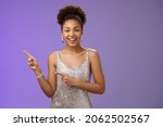 Good-looking elegant confident african-american female club owner pointing upper left wear stylish evening night dress smiling assured suggest comfortable place stay enjoy party, blue background