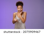 Small photo of Attractive surprised charismatic african-american woman in silver glittering stylish dress widen eyes gasping amazed touch cheek impressed astonishing perfect gift pointing down cannot believe