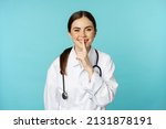 Small photo of Smiling cute doctor woman, shush, press hush shh sign with finger pressed to lips, hiding secret, taboo gesture, standing over torquoise background