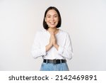 Portrait of happy asian girl laughing and smiling, showing thank you, namaste gesture, grateful for smth, standing over white background