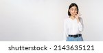 Small photo of Mouth shut. Young asian woman seal lips, showing taboo dont speak, keep quiet sign, hiding secret, standing over white background