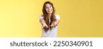 Small photo of Come closer take my hand. Cheerful lovely charismatic tender woman extend arms forward camera wanna hold receive charming gift tilt head smiling pleased grateful stand yellow background. Copy space