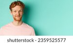 Small photo of Close up of redhead bearded man looking pleased, nod in approval and smiling, standing in pink t-shirt against turquoise background.