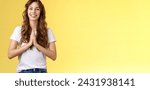 Small photo of Cheerful confident outgoing young polite girl say namaste greeting asian guests smiling gladly thanking for visit hold hands pray supplication gesture asking favour begging stand yellow background