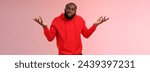 Small photo of Bothered pissed african american bearded boyfriend in red hoodie arguing standing questioned bothered stupid accusations shrugging raise hands dismay cringing perplexed, pink background.