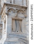 Small photo of Ancient marble detail of Babel tower on the front of the dome in Milan, Italy