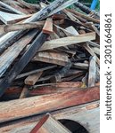 Small photo of A pile of wooden waste material lies in disarray, discarded and forgotten. The scraps of wood are of various sizes and shapes, some are long and slender while others are thick and cumbersome. The roug