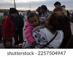 Small photo of Juarez, Mexico, 11-11-2022: woman tries to reassure her daughter in the migrant camp set up on the Juarez-El Paso Texas border, migrants await the end of title 42.
