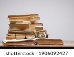 A Stack Of Old Books With...