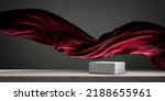Small photo of Luxury product placement scene background with stone cube podium on marble table and red fabric float. Premium beauty and fashion product display mockup. Flying silk cloth in aesthetic interior studio