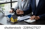 Small photo of Real estate broker agent presenting and consult to customer to decision making sign insurance form agreement, home model, concerning mortgage loan offer in office