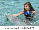 Girl Swimming With Dolphin