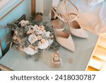 Small photo of ISTANBUL, TURKEY - MARCH 17, 2023: The LAB brand bridal shoes, Chloe brand women's perfume, wedding rings, and bridal bouquet are displayed decoratively.
