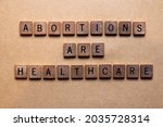 Small photo of Wooden letters spelling out abortions are healthcare. Relevant to the Texas SB8 law that bans virtually all abortions after six weeks based on the heartbeat principle. Women's rights, reproduction.