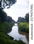 Small photo of selokan river in yogyakarta, indonesia or saluran irigasi selokan mataram untuk pertanian sawah dan kolam ikan, peninggalan dari Raja Jogja