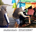 Small photo of fisherman boat at beach in Indonesia, June 13, 2023, pengunjung wisata pantai widuri pemalang, sedang naik perahu nelayan dengan biaya 20 ride a fishing boat, as a tourist destination selama 15 menit