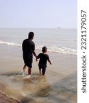 Small photo of The people at beach. Indonesia, June 22, 2023, anak anak dan pengnjung, wisatawan berlibur dan bermain ombak pasir air pantai widuri, pantai ombak kecil, pantai utara pula jawa, ombak tenang landai