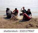 Small photo of The people at beach. Indonesia, June 22, 2023, anak anak dan pengnjung, wisatawan berlibur dan bermain ombak pasir air pantai widuri, pantai ombak kecil, pantai utara pula jawa, ombak tenang landai