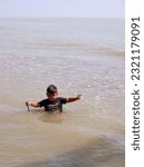 Small photo of The people at beach. Indonesia, June 22, 2023, anak anak dan pengnjung, wisatawan berlibur dan bermain ombak pasir air pantai widuri, pantai ombak kecil, pantai utara pula jawa, ombak tenang landai