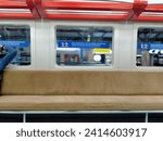 Small photo of the train station at Yogyakarta city, Indonesia, January 19, 2024 interior of the electric train cabin, KRL to Jogja Solo PP, there are seats, handrails, above, in the form of a ring, yellow, with a h