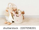 Small photo of Beige Toy Storage Baskets in the children's room. Cloth stylish Baskets with toys and rag dolls. Organizing and Storage Ideas in nursery. Clean up toys and reduce the clutter. House cleaning.