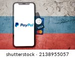Small photo of Kharkiv, Ukraine - March 13, 2022 : russian sanctions, paypal sanctions in russia, paypal leaving the russian market, iphone with paypal logo and visa and master card cards