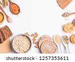 Different types of high carbohydrate food. Flour, bread, dry pasta and lentils and other ingredients on the white background.