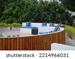 Outdoor tables and sofas on roof terrace background.