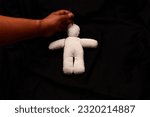 Small photo of A shaman puts a deadly curse on a cotton doll used to curse death