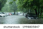 Small photo of Flooded cars on the street of the city. Street after heavy rain. Water could enter the engine, transmission parts or other places. Disaster Motor Vehicle Insurance Claim Themed. Severe weather concept