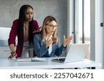 Small photo of Two multiethnic business women in suit having problems with laptop, system being hacked stopped working lost internet connection in middle of important work, feeling frustrated over deleted lost data.