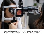 	
Eye doctor performing an eye fundus examination with retinal camera.