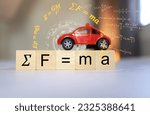Small photo of Sir Isaac Newton's equation of motion, force equal to mass times acceleration, or F equal to m multipleply by a on a model car and a wooden cube.