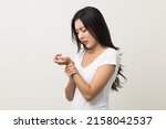 Small photo of A woman has an inflamed wrist because she is overworked. She massaged her wrists to soothe and relax. Shot on isolated white background.