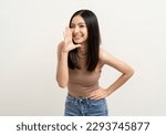 Small photo of Happy beautiful asian woman with copy space. Excited pretty girl shout out loud wow with hands on mouth announcement standing pose on isolated white background.