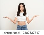 Beautiful smiling happy young asian woman in white shirt. Charming female lady open hands palm up holding something on isolated white background. Asian cute Pretty people looking copy space.