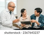 Small photo of Asian family discussing fertility with a pediatrician. Young couple patients in fertility clinic consulting about IVF or IUI with doctor. Couple relationship therapy with a counselor
