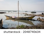 Small photo of DUNGA, KENYA - SEPTEMBER 20, 2021: traditional wooden fishing boat on the shores of Lake Victoria where overfishing and the spread of water hyacinth wreak havoc on the local fishing industry.