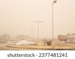 Small photo of KUWAIT CITY, KUWAIT - OCTOBER 19, 2023: Migrant workers in Kuwait keep on toiling during a sandstorm. The Gulf emirate is accused of failing to tackle widespread labour rights abuses.