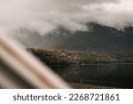 view of the lake from the van with two ducks swimming calmly towards the lonely wooden platform with metal ladder in an environment of plants and trees under the stormy clouds in the middle of nature
