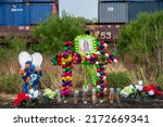 Small photo of San Antonio, Texas United States - June 28, 2022: Texans brought prayer candles, bottles of water, and religious icons to a makeshift memorial at the site where 46 migrants were declared dead Monday