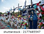 Small photo of San Antonio, TexasUnited States - July 1, 2022: A makeshift memorial at the site where more than 50 migrants were found in a tractor trailer continues to grow on the southwest side of San Antonio
