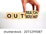 Small photo of Outreach or outbound symbol. Businessman turns wooden cubes and changes the word 'outbound' to 'outreach'. Beautiful white table, white background. Business, outreach or outbound concept. Copy space.