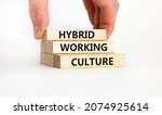 Small photo of Hybrid working culture symbol. Concept words 'hybrid working culture'. Businessman hand. Beautiful white background. Business and hybrid working culture concept, copy space.