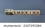 Small photo of Quit smoking 2022 new years resolution symbol. Turned wooden cubes with words '2022 quit smoking'. Beautiful grey background, copy space. Healthy lifestyle and 2022 quit smoking concept.