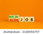 Extra or side job symbol. Turned wooden cubes and changed concept words Side job to Main job. Beautiful orange table orange background, copy space. Business side or main job concept.
