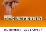 Small photo of Humanity or inhumanity symbol. Businessman turns wooden cubes changes the word inhumanity to humanity. Beautiful orange table orange background, copy space. Business, humanity or inhumanity concept.