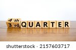 Small photo of From 3rd third to 4th forth quarter symbol. Turned wooden cubes and changed words 3rd quarter to 4th quarter. Beautiful wooden table white background. Business happy 4th quarter concept. Copy space.