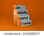 Small photo of LIIT low-intensity interval training symbol. Concept words LIIT low-intensity interval training on blocks on a beautiful orange background. LIIT low-intensity interval training concept. Copy space.