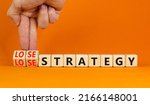 Small photo of Lose-lose strategy symbol. Businessman turns wooden cubes with words lose lose strategy. Beautiful orange table, orange background. Business, lose-lose strategy concept. Copy space.